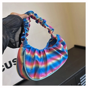 Detailed view of rainbow gradient pleated handbag with silky texture and cloud shape