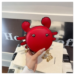 Detailed view of a red crab-shaped PU leather crossbody bag with a gold chain strap