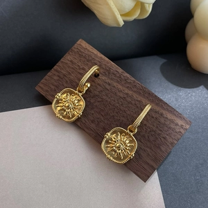 French vintage matte gold sunflower earrings on a wooden display stand for women