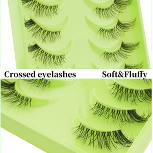 Close-up of soft and fluffy crossed half-eyelashes in a light green plastic tray