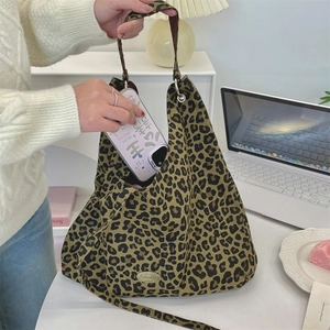 Detailed view of leopard print tote bag interior showing spacious capacity for a smartphone