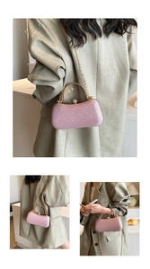 Detail of pink sequin evening clutch bag with gold handle and chain on a gray suit