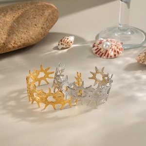Textured 18K gold and silver stainless steel irregular thorn bangles in a luxury display