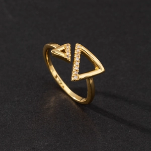 Macro shot of gold adjustable open ring featuring geometric triangle pave set cubic zirconia