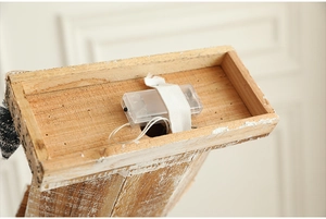 Detail of the battery compartment and power switch on the wooden light-up cabin ornament