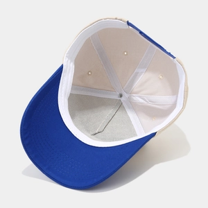 Detailed interior of a two-tone baseball cap featuring blue visor and adjustable snapback