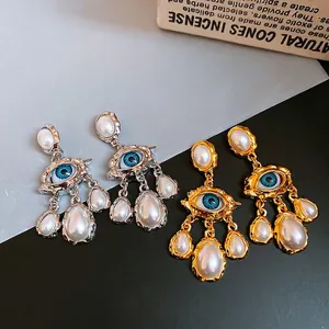Vintage eye earrings with blue center and drop pearls on silver needles for women