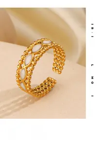 Detail of 18K gold-plated beaded ring with marquise white shell inlays and wave design