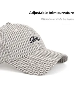 Detail view of the black and white plaid baseball cap featuring custom letter embroidery