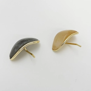 Detail of gray and beige marble resin hair clips with elegant gold metal trim design