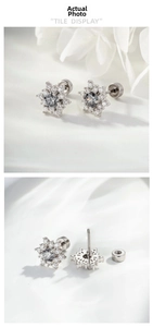 Macro detail of snowflake cartilage earrings with grey main stone and screw-back posts