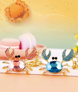 Detail of pink and blue rhinestone crab keychains with sparkling faceted crystal stones