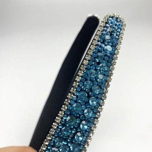 Macro detail of blue and silver rhinestones on luxury black non-slip headband