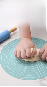 Close-up of 30cm blue silicone pastry mat with scale markings and rolling pin