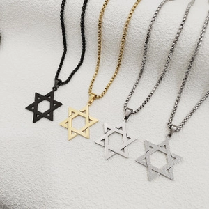 Flat lay of stainless steel Star of David necklaces in black, gold, and silver finishes