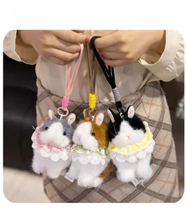 Detailed view of plush rabbit keychains in gray brown and black with lace collars