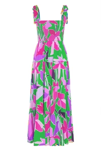 Detailed view of tiered skirt with vibrant magenta and lime green abstract floral patterns