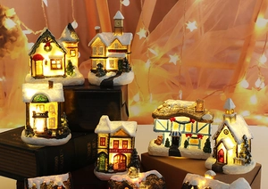 Group view of LED lighted Christmas resin houses with snow textures and holiday glow