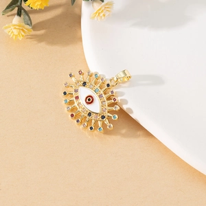 Macro detail of golden evil eye pendant with colorful gemstones and white enamel inlay