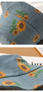 Detail of sunflower prints and stitching on a light blue denim baby sun hat