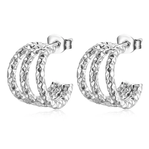 Detailed close-up of triple-layered silver stainless steel C-shaped earrings with quilted texture