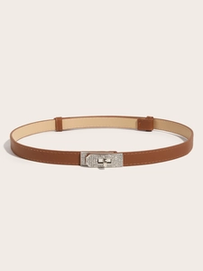 Close-up of brown textured leather slim belt with sparkling rhinestone studded lock buckle