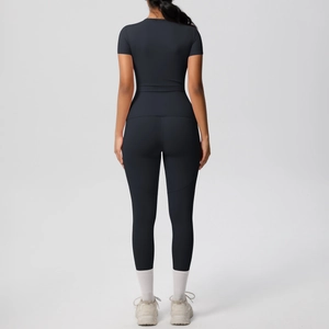 Detail view of black high-stretch two-piece yoga set showing back stitching and body fit