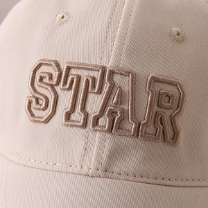 Close-up of premium Star letter 3D embroidery on a beige kids twill cotton baseball cap