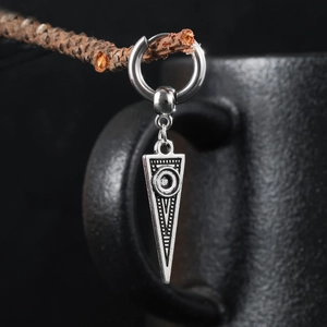 Polished silver stainless steel inverted triangle earring hanging on a wooden branch