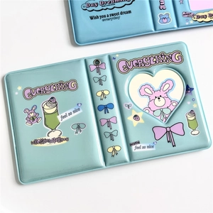 Detail of blue and cyan PVC photo album sleeves with cute bear and rabbit cartoon patterns