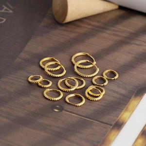 Detailed view of multiple sizes of gold beaded S925 sterling silver hoop earrings