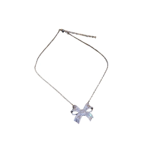 Elegant silver bow pendant necklace with sparkling cubic zirconia on a white background