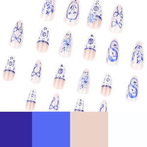 Blue and white porcelain style almond press-on nails with floral and bow patterns