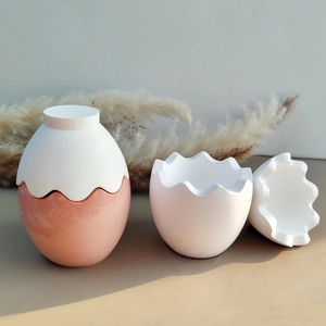 Detail of egg-shaped candle holder mold with white and orange marble texture design