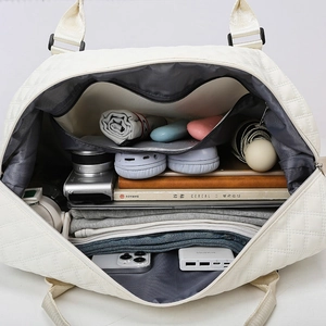 Spacious quilted travel bag with large interior capacity for clothes and electronics