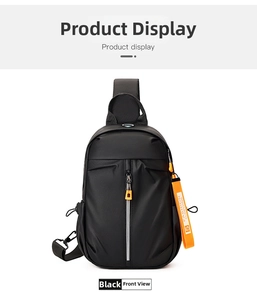 Detail of black nylon chest bag featuring a front vertical zip and orange fashion pull tab