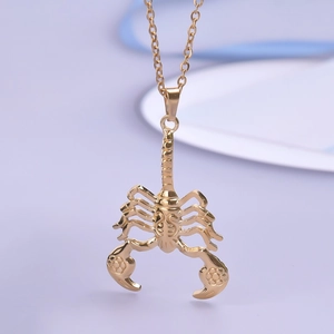 Close-up of a 18K gold-plated stainless steel scorpion pendant with detailed craftsmanship