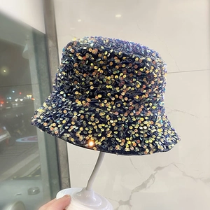 Detailed macro shot of shimmering sequins on the colorful bucket hat fabric texture