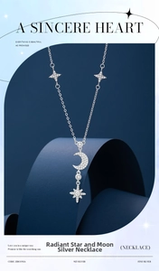 Detail of 925 silver crescent moon and star pendant with cubic zirconia on blue display