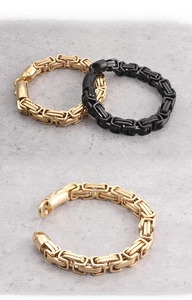 Detail of masculine Byzantine chain bracelet with dual-tone gold and matte black finish