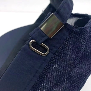 Detail of adjustable metal buckle and breathable mesh fabric on dark blue baseball cap