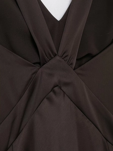 Detail of dark brown satin dress featuring cross V-neck and elegant draped pleats