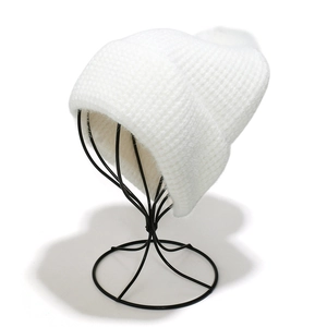Detail view of the soft white faux mink fur knitted beanie with plush fuzzy texture