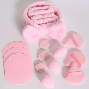 Pink makeup set featuring a bow headband and various makeup sponges on a plain background