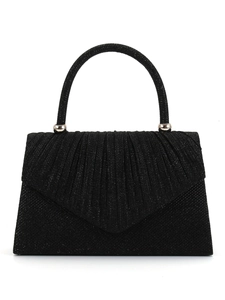 Close-up detail of the black glitter evening handbag featuring pleated flap design and metal handle.