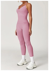 Pink seamless yoga set with V-neck ruched tank top and high-waisted leggings on model