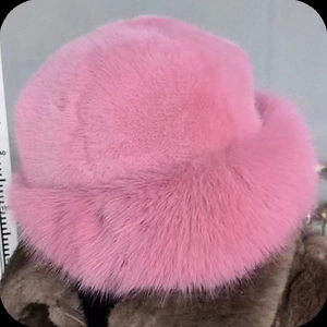 Detailed macro view of plush pink faux fur texture and rolled edge on winter hat