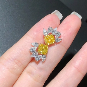 Luxury drop earrings with yellow zircon centers and white wing-shaped gemstone accents
