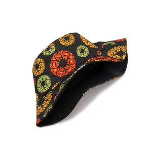 Black reversible sun bucket hat with colorful circular floral patterns and wide brim