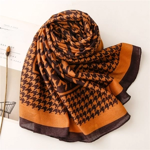 Detail of orange houndstooth scarf with brown borders and breathable cotton linen texture
